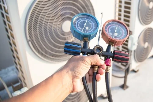 650b2bea342e13645581d8ad_ac maintenance tech inspecting an air conditioner 1
